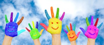 Summer holidays, childhood and family concept. Happy family hands in colorful paints with smiles on background of blue sky with clouds. The bright colors of summer